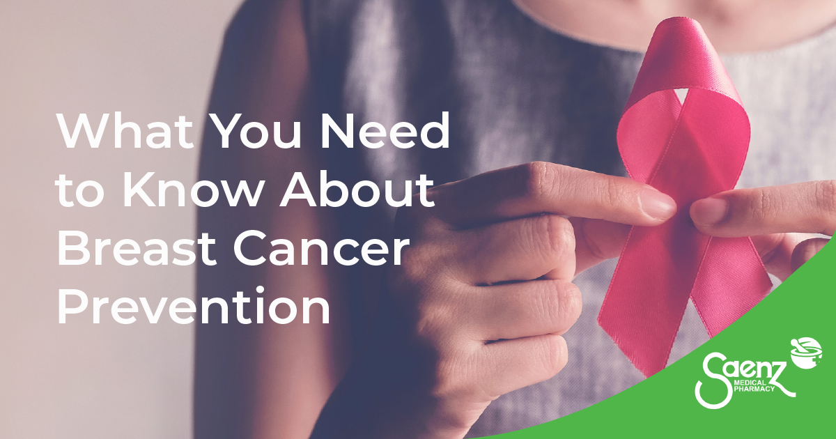 Woman holding a pink breast cancer awareness ribbon out in front of her. Breast Cancer Awareness Ribbon.jpeg